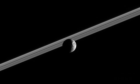 Mimas in front of Jupiterâ€™s rings